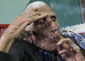 Banos smokes a cigar in his house during his 111th birthday celebration in Havana Photo Courtesy of Dailymail.co.uk